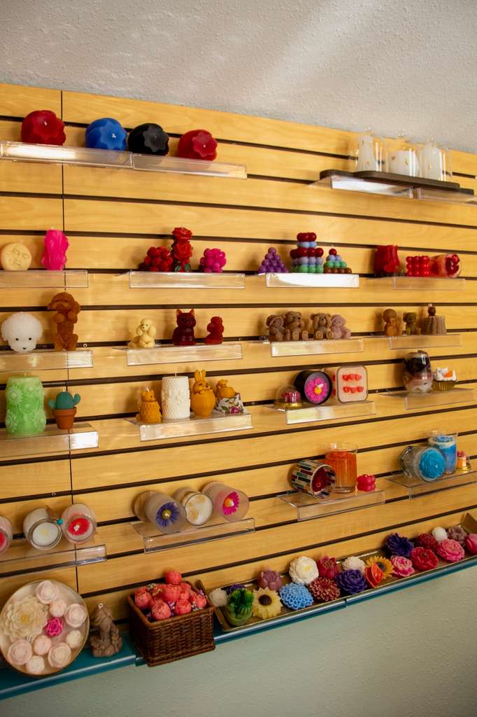 A wall of finished handmade candles in many shapes