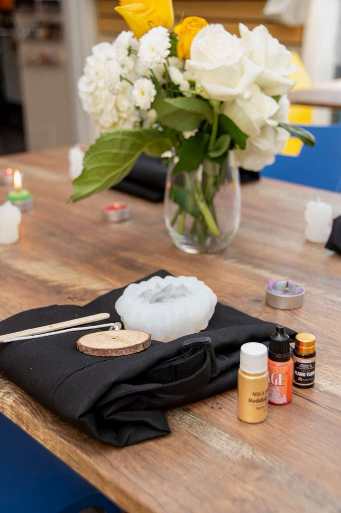 Apron, mold, wooden disc and oils laid out at a place setting