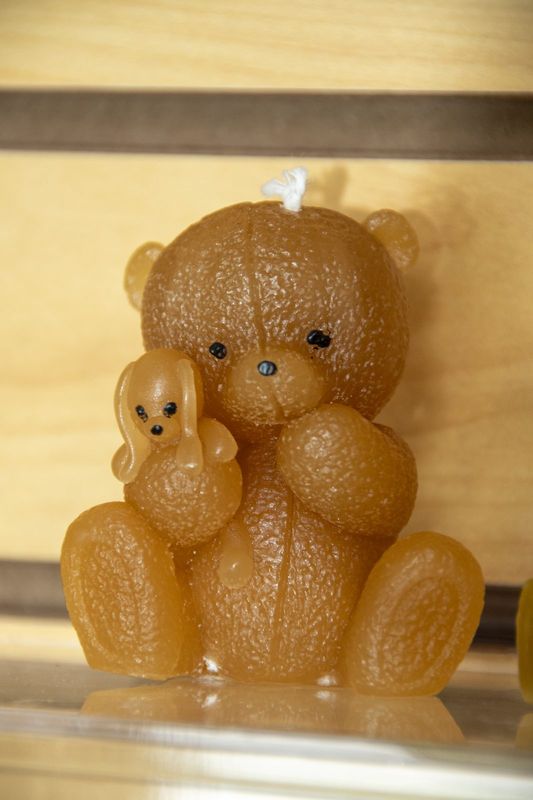 An amber bear candle holding a smaller cub